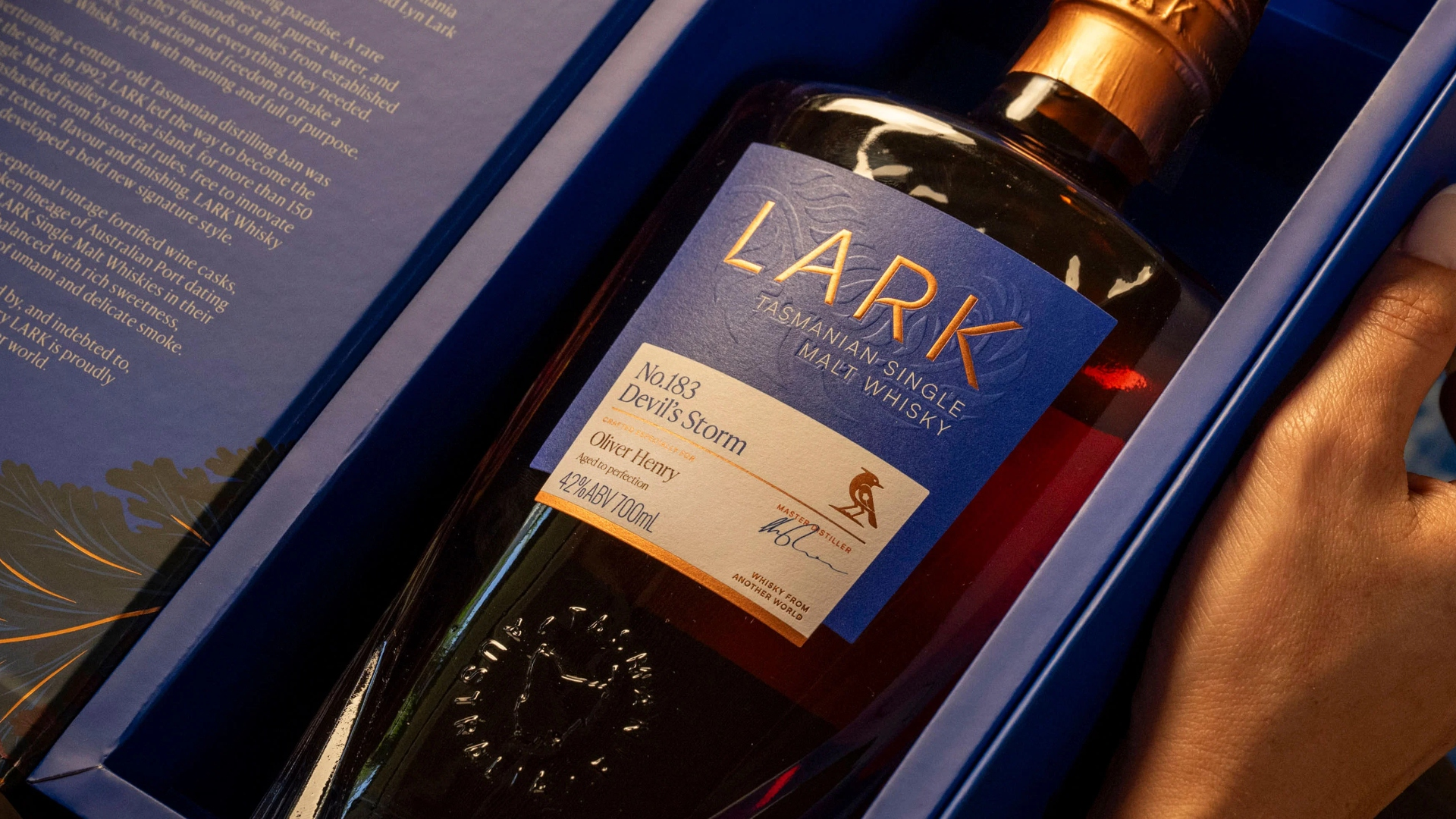 Lark Tasmanian Single Malt whisky bottle (No.183 Devil's Storm) with a tailored label printed for Oliver Henry, presented in its navy gift box